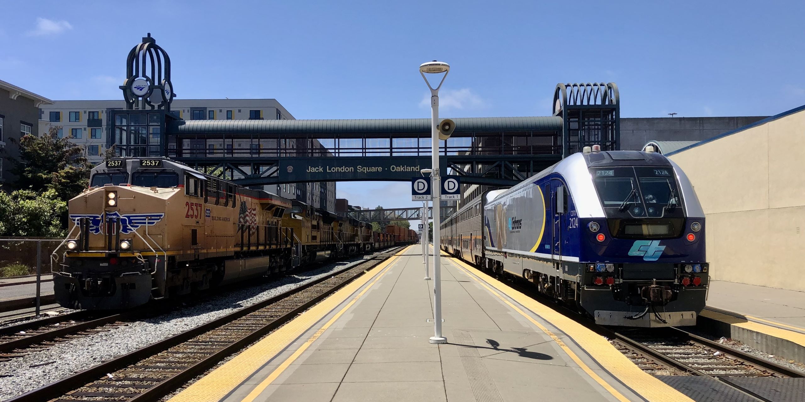 Siemens Charger and Union Pacific diesel locomotives at Oakland Jack London Square Station.
