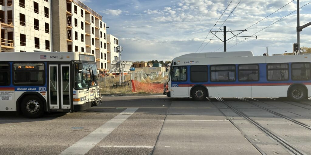 RTD buses at the R Line grade crossing, Aurora Metro Center.