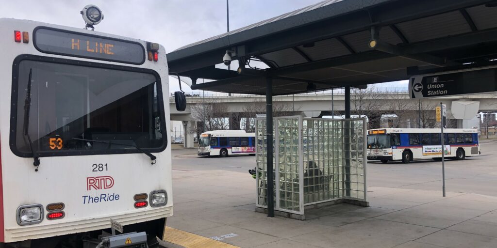 H Line train and 0 buses at I-25 & Broadway Station.